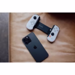 Backbone One PlayStation Edition Lightning 2nd Gen controller with iPhone resting on leather surface